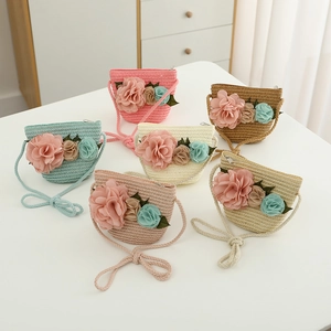 Detail showing colorful woven straw bags for girls with 3D fabric flower decorations