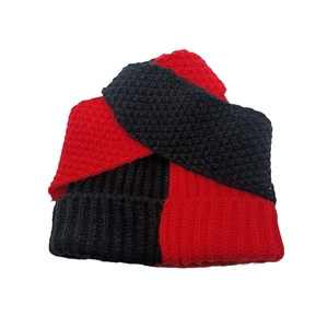 Close-up of the chunky red and black knit texture on a cozy winter rabbit hat