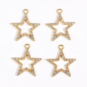 Macro detail of four gold-plated star pendants with pavé-set cubic zirconia stones