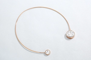Detail of rose gold open choker necklace featuring asymmetric round zircon crystals