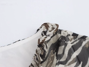 Detail of tiger print chiffon fabric featuring ruffled edges and soft inner lining