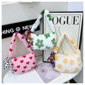 Close-up of plush shoulder bags with floral and heart patterns and decorative silk scarves