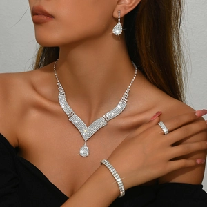 Detail view of silver bridal jewelry set with sparkling rhinestones on model