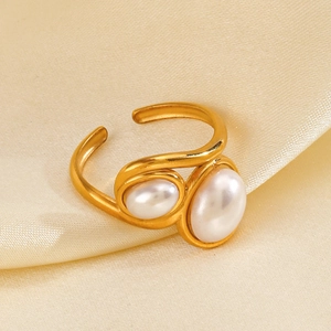 Vintage adjustable gold stainless steel ring with elegant double pearls on satin background