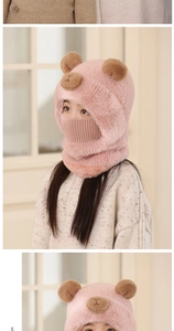 Close-up of pink plush bear hat with integrated face mask and neck warmer for winter