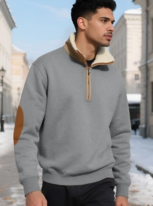 Detail of grey half-zip sweatshirt with white fleece collar and brown faux leather elbow patches