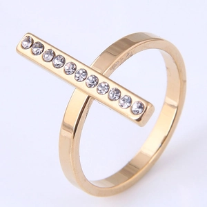 Detail shot of golden geometric ring featuring a rectangular bar set with 11 zircon stones