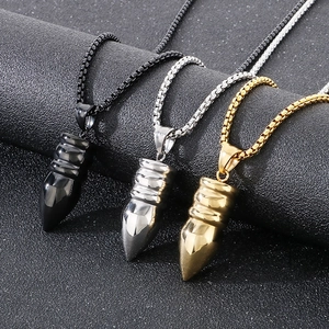 Detailed shot of bullet pendants in black, silver, and gold with matching box chains