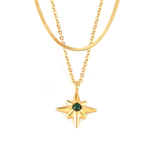 Double-layered gold necklace with flat snake chain and emerald green star pendant