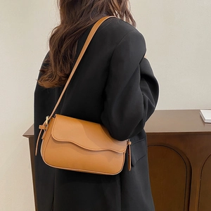 Minimalist brown PU leather square shoulder bag with wave flap design and adjustable strap