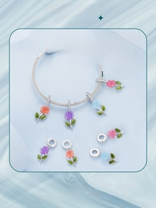 Detailed macro view of S925 sterling silver snake chain bracelet with colorful rose charms