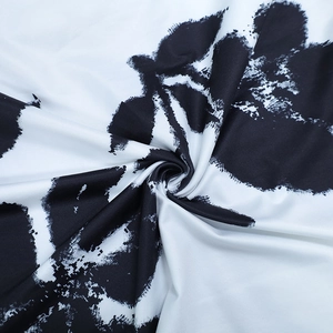 Detailed macro view of black and white abstract ink print fabric with smooth texture