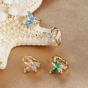Detail of four butterfly cartilage earrings with colorful cubic zirconia on starfish