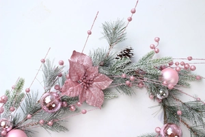 Detailed view of Barbie pink Christmas wreath with glitter flowers and frosted pine needles