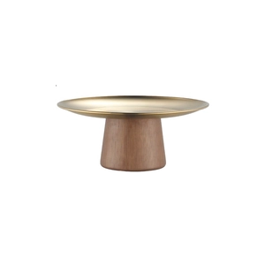 Detail of a minimalist gold metal snack platter with a premium cylindrical wood pedestal base