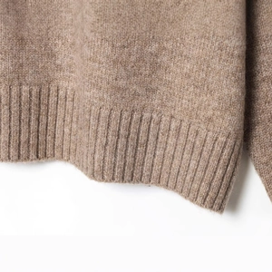 Brown knit sweater with plush texture and detailed ribbed hemline and cuffs