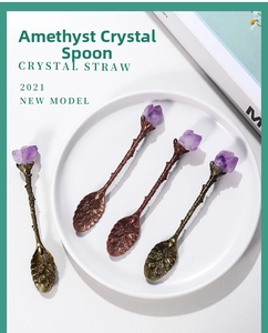 Detail of vintage copper coffee spoons with raw amethyst crystals and floral engravings