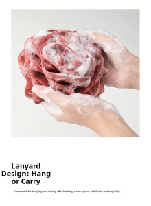 Macro detail showing a rose-shaped bath sponge producing rich foam with hanging rope
