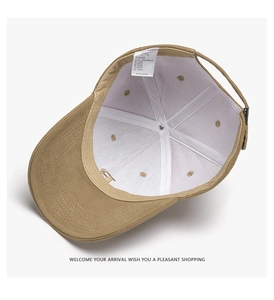 Detail view of khaki cotton baseball cap interior with sweatband and adjustable metal buckle