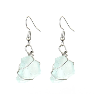 Detail of handmade silver wire wrapped natural light blue gemstone drop earrings
