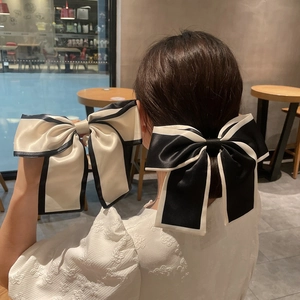 French style oversized satin bow hair clip with contrasting piping for elegant ponytails
