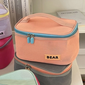 Detail of colorful mesh cosmetic bags with double zippers and sturdy webbing handles
