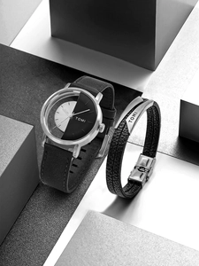 Detail of TOMI watch with black leather strap and matching braided stainless steel bracelet