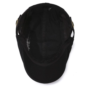 Inside view of black cotton flat top hat with gold metal buckle and skull rivet details