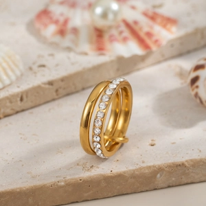 Double-layered 18K gold plated titanium ring with pavé diamonds on a light stone base