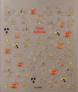 Macro shot of Halloween nail stickers with embossed gold pumpkin, ghost, and bat patterns