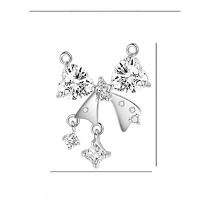 Detail view of bowknot pendant with heart and square zircon in copper and silver finish