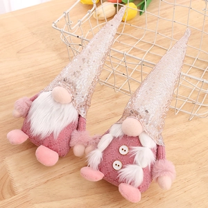 Set of pink and champagne sequin Nordic gnome plush dolls on a light wood tabletop