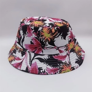 Detail of white bucket hat featuring pink and orange floral print and premium stitching