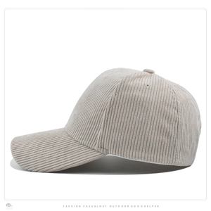 Close-up of beige corduroy baseball cap showing fine ribbed texture and curved brim