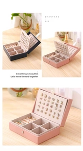 Close-up of portable jewelry organizer with ring slots and necklace hooks in two colors