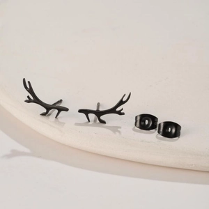 Close-up of matte black stainless steel reindeer antler earrings with butterfly backs