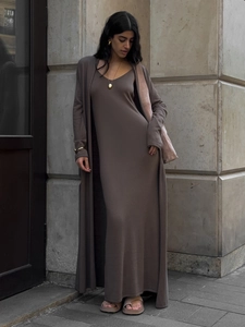 Close-up of elegant dark coffee knitted two-piece set featuring long cardigan and maxi dress