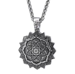 Macro detail of silver vintage mandala pendant with lotus patterns and wheat chain