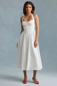 Detail of white halter neck dress with front buttons and pleated waist design