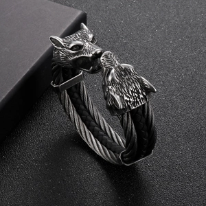 Macro detail of men's viking wolf head bangle with stainless steel braided wire texture
