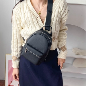 Versatile black pebbled leather crossbody chest bag with adjustable wide strap and silver zippers