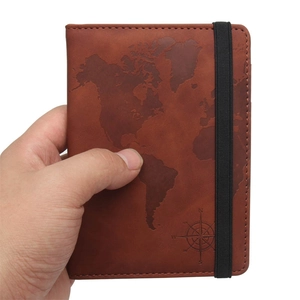 Brown leather passport cover with vintage world map and elastic strap closure