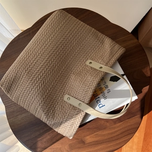 Detail of wheat ear pattern canvas tote with cream faux leather handle and silver rivets