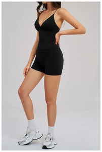 Detailed side view of a black two-piece yoga set with V-neck camisole and high-waisted shorts