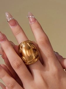 Detail of 18k gold plated chunky titanium steel ring with polished oval surface