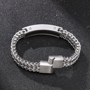 Detail of silver square chain men's bracelet with brushed steel plate and folding clasp