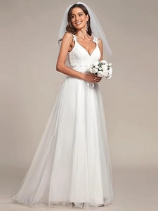 Detailed view of 3D floral lace embroidery on white deep V-neck wedding dress bodice
