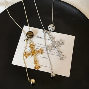Detail of luxury cross necklaces with rhinestones, semi-precious beads and snake chains
