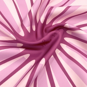 Detailed view of pink silk scarf texture with radial stripes and soft satin sheen