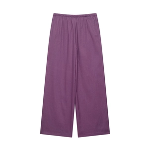 Detailed view of purple wide-leg trousers with elastic waistband and woven texture